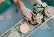 Elegant spa setting with flowers, bath salts, and calming ambiance for ultimate relaxation.